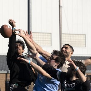 Students trying to catch a football.