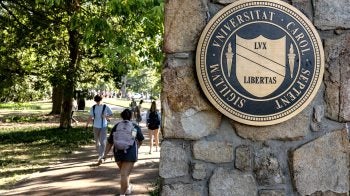 UNC-Chapel Hill seal posted to a stone column. Students are seen walking down the sidewalk next to Cameron Avenue.