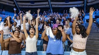 Students learn cheers during a pep rally at Carmichael Arena during Weeks of Welcome