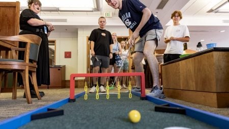 UNC-Chapel Hill students playing mini golf inside Davis Library during the University's 2024 Weeks of Welcome.