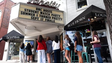 Students wait outside the Varsity Theatre to get prime seating for the watch party.