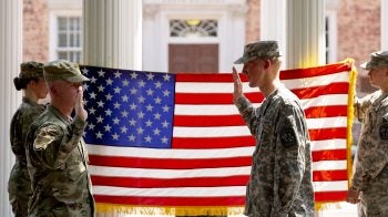 UNC-Chapel Hill ROTC members taking an oath to serve while standing by an American flag near the Old Well on the campus of UNC-Chapel Hill.