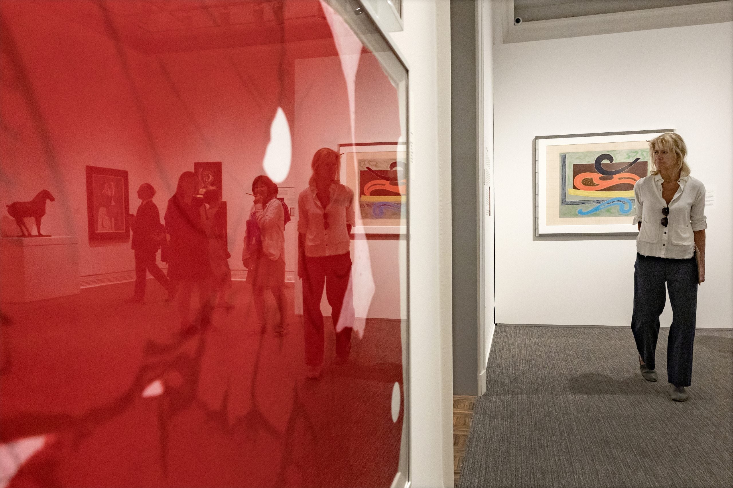 Visitor looking at ‘Four Red Flowers’ by Donald Sultan.