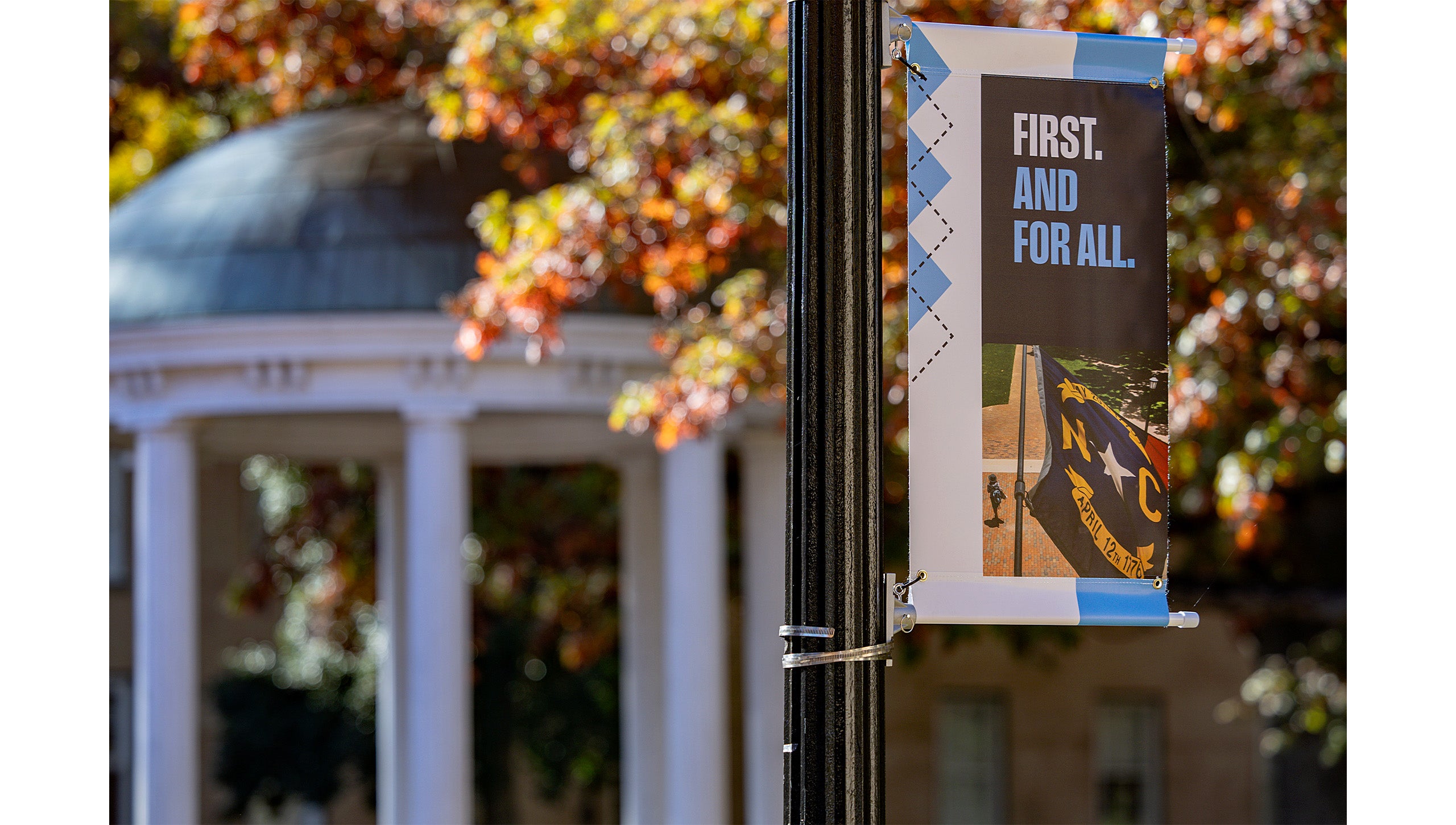 A UNC-Chapel Hill branded pole banner reading 