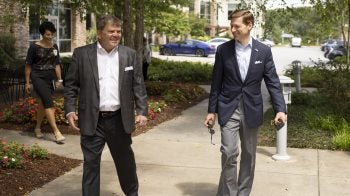 Chancellor Lee H. Roberts speaks with Bill Hathaway, C.E.O. of M.A.H.E.C., while walking outside