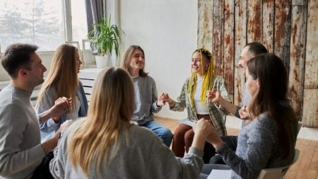 A group of people holding hands in a group activity.