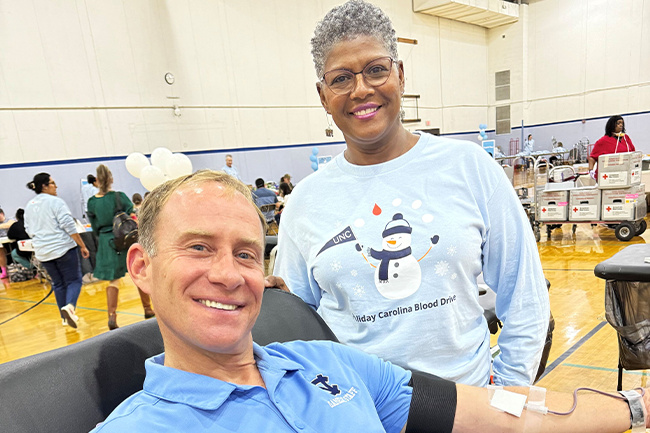 A volunteer and blood donor pose for a photo at the annual Carolina Blood Drive.