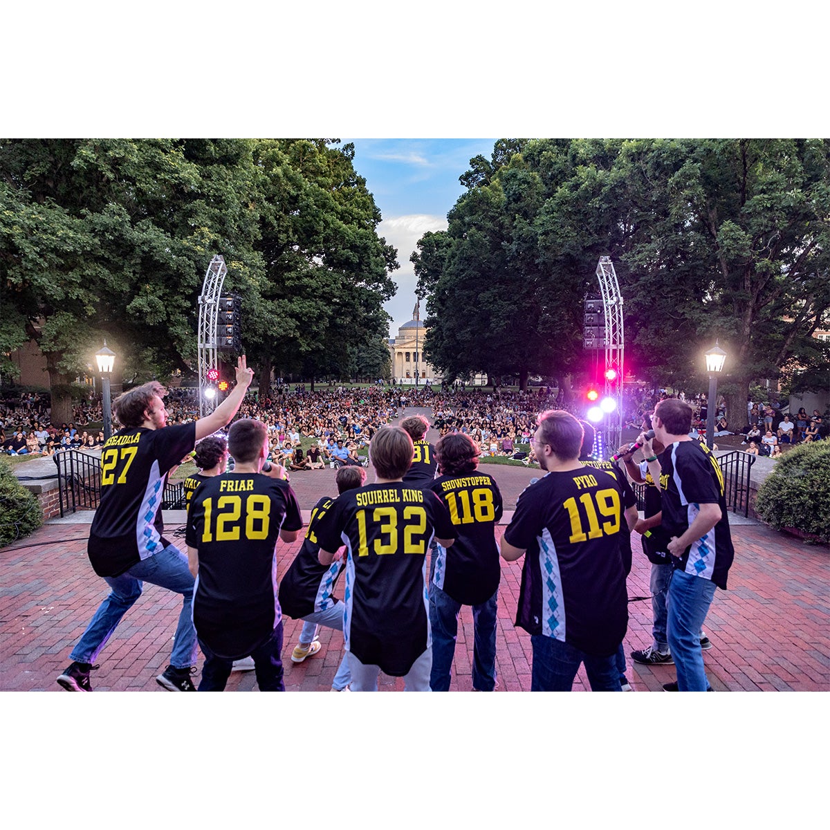 An a cappella group singing to an audience of students on the campus of UNC-Chapel Hill.