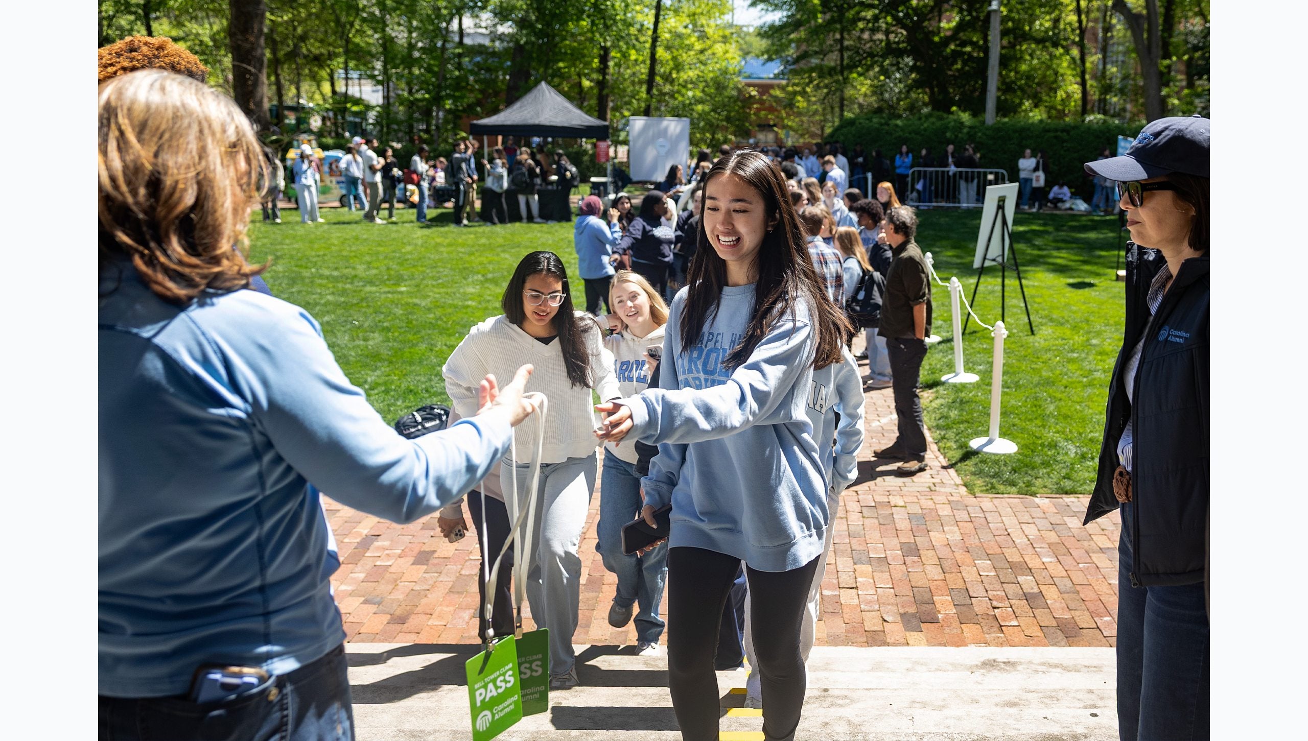 Students waiting in line to climb the Bell Tower on the campus of UNC-Chapel Hill and getting read to grab a pass needed to do so.