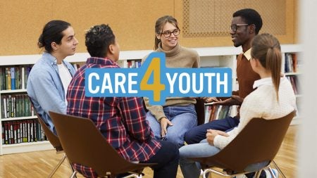 Group of teenagers seated in chairs forming a circle in a classroom with graphic text overlayed reading: 