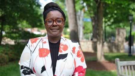 Constance Lindsay poses for a photo in front of the Davie Poplar tree on U.N.C. campus.