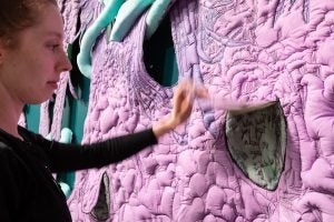 Visitor lifting flap to read message on "Soft Night, Watching".