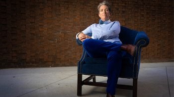 Gabrielle Calvocoressi posing for a portrait in a chair.