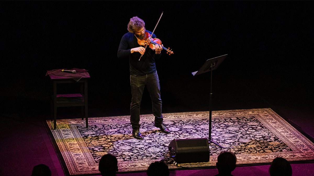 Johnny Gandeslman plays his violin in front of an audience.