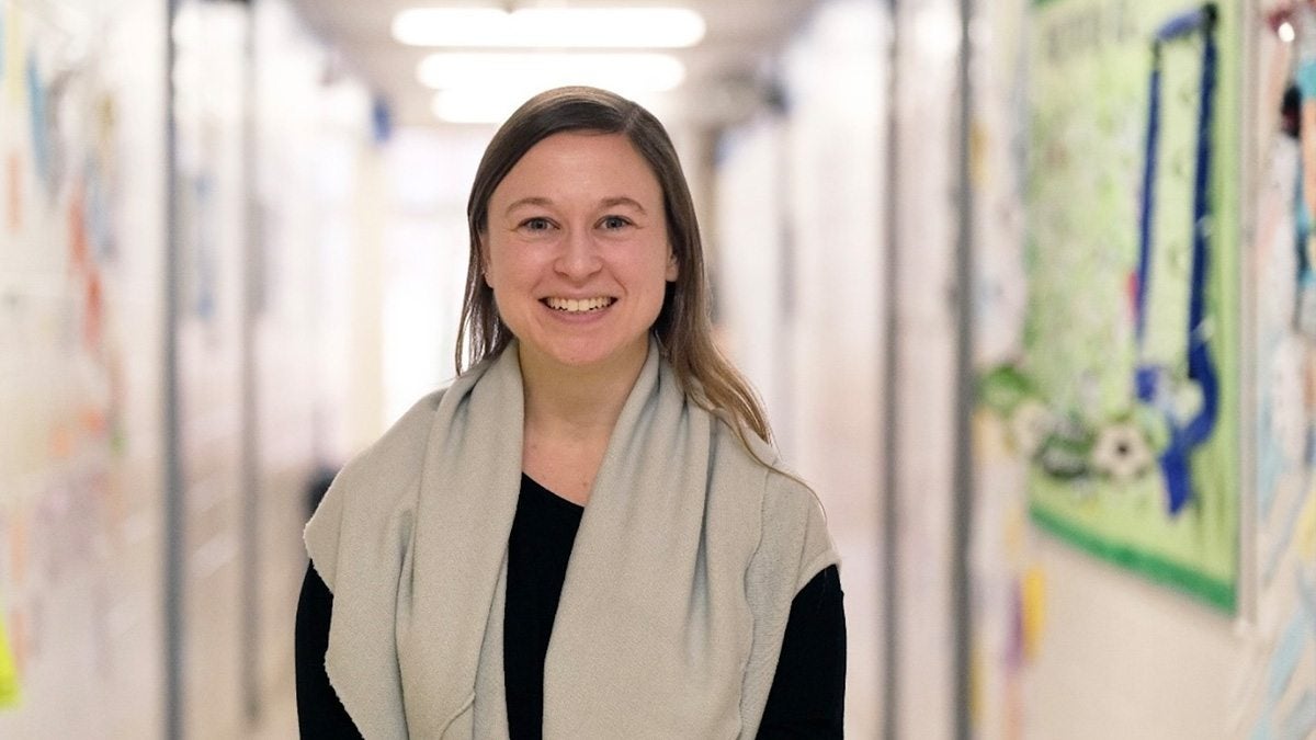 Annie Goldberg stands in a school hallway.