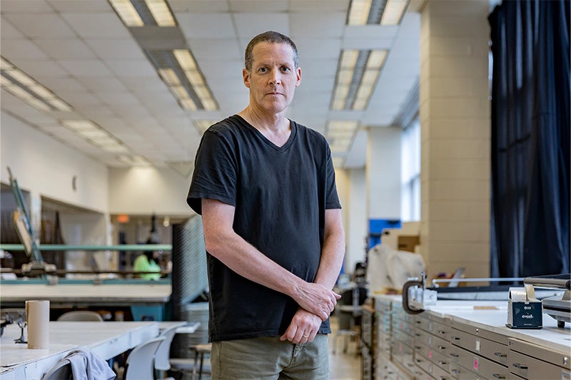 Bob Goldstein posing for a portrait in an art classroom in Hanes Art Center on the campus of UNC-Chapel Hill.