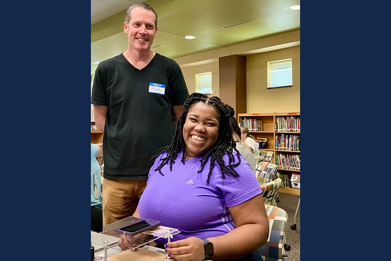 Bob Goldstein posing for a photo with an elementary school teacher who assembled a DIY microscope at a workshop Goldstein led.