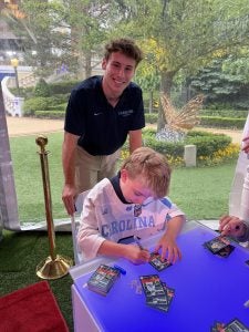 Noah signing autographs.