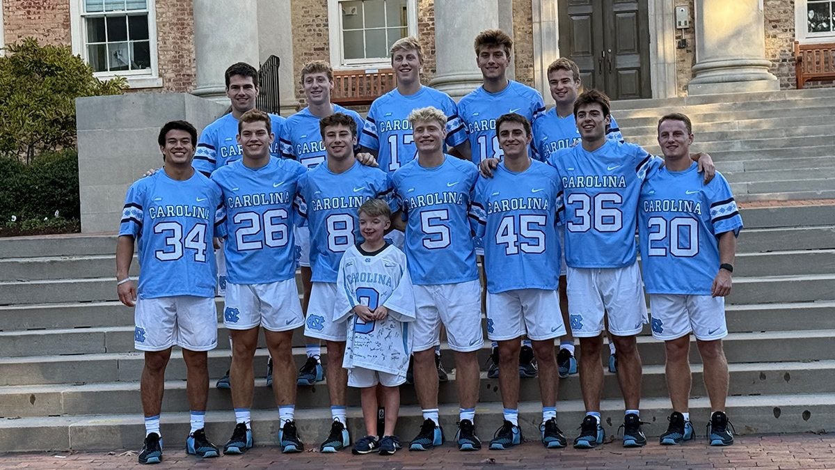 Lacrosse team posing for group photo.
