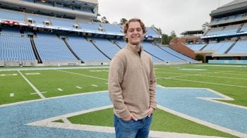 Kyle Lobenhofer stands on field at Kenan Stadium