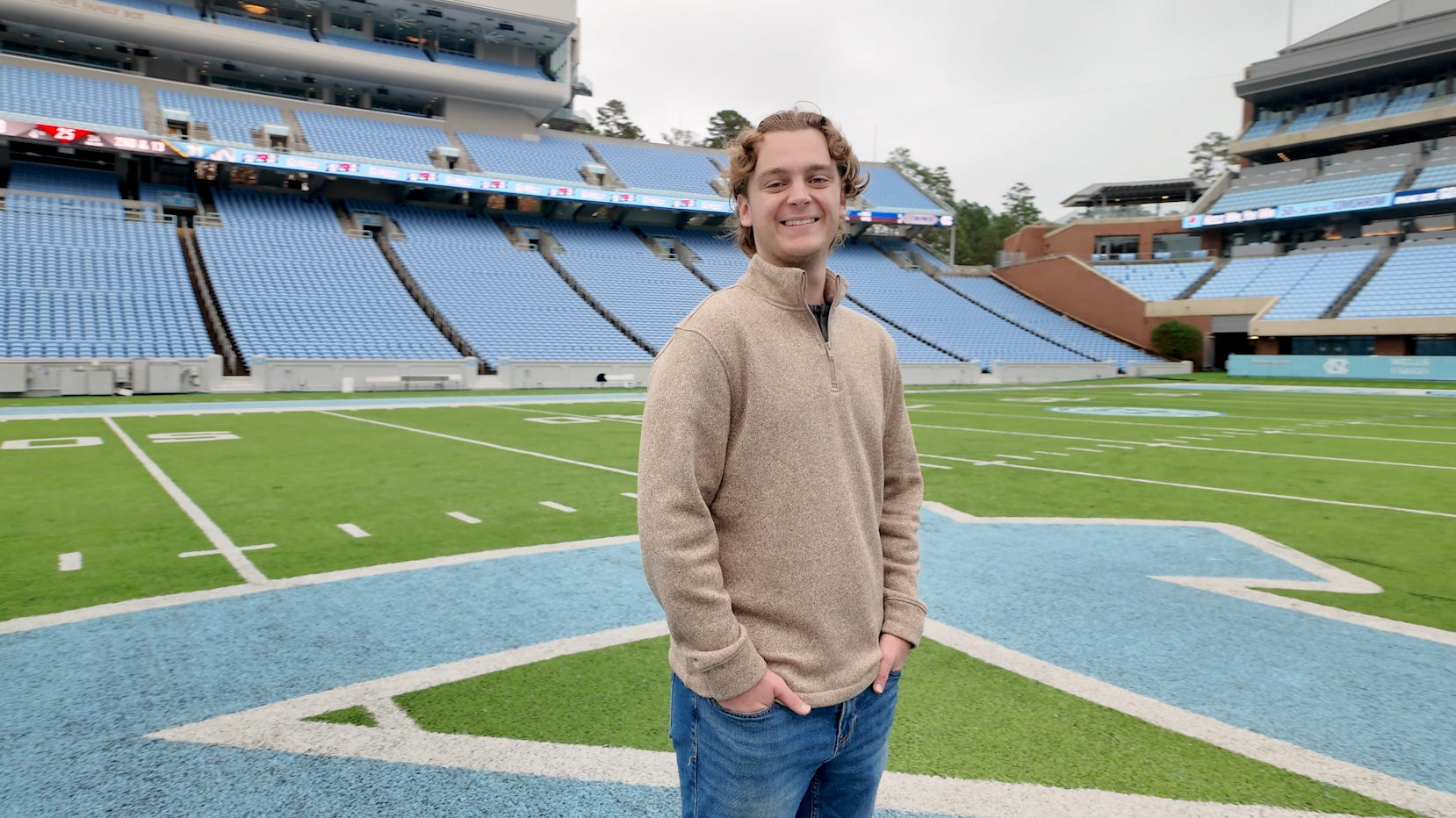 Kyle Lobenhofer stands on field at Kenan Stadium
