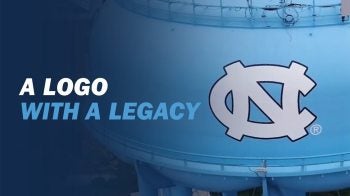 Close-up drone image of the NC logo branded Carolina Blue water tower on the campus of UNC-Chapel Hill with graphic text placed nearby it reading: 