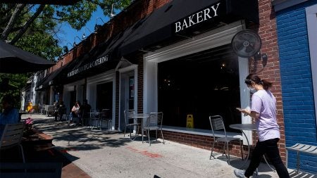 People walk on the sidewalk on Franklin Street.