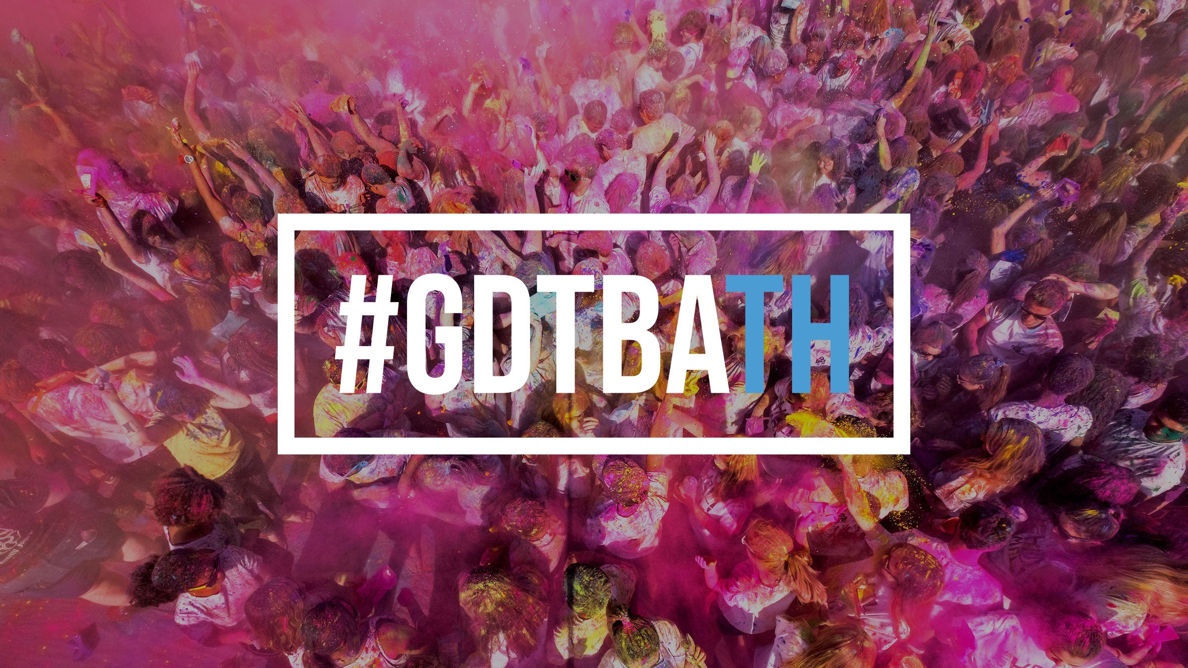 A photo of students throwing colorful powder with the hastag 