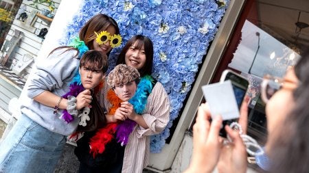 Students pose with photos of the cast members of 