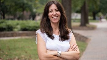 Francesca Tripodi stands on a brick pathway on the campus of U.N.C.-Chapel Hill