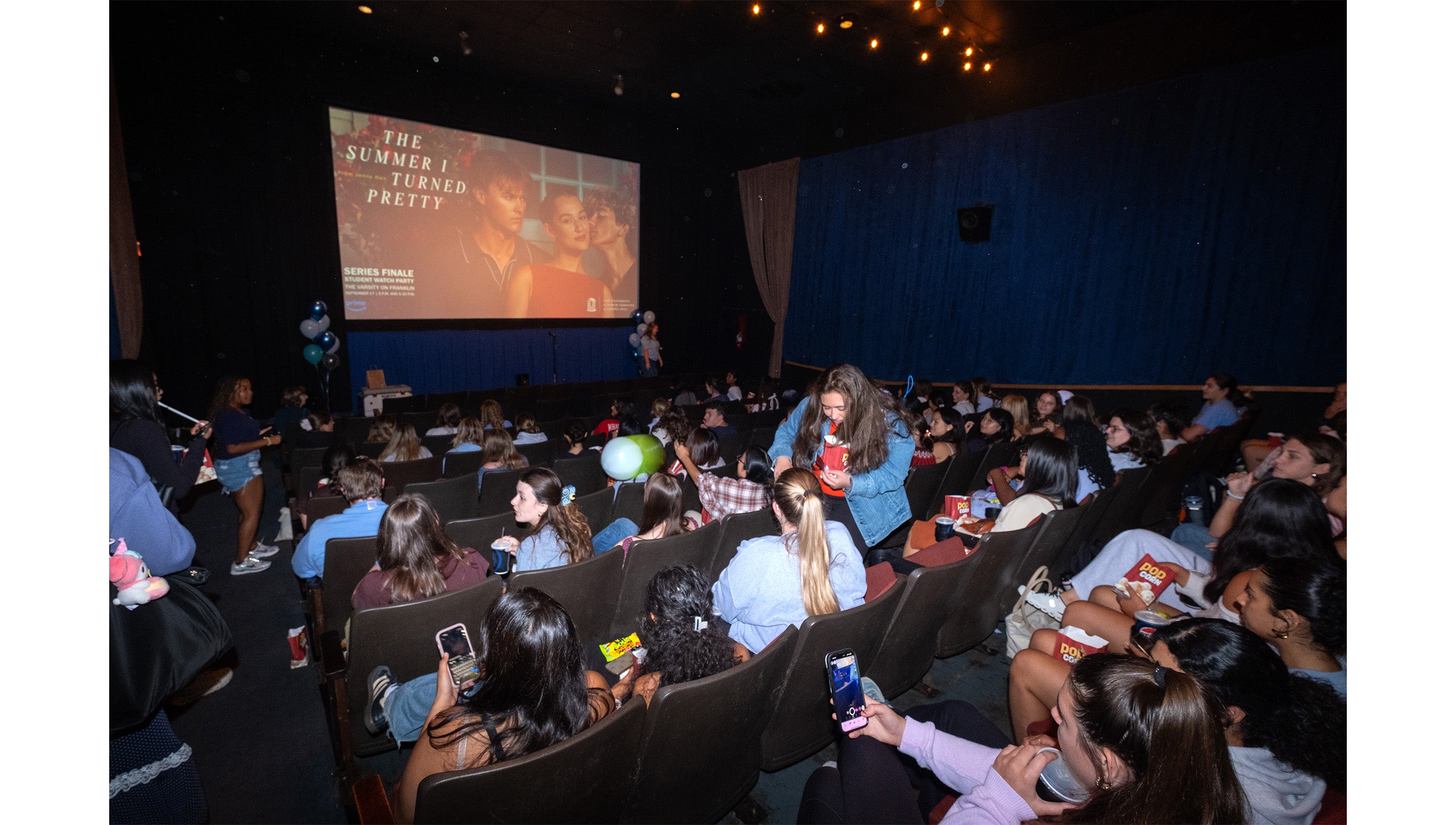 Theater full of UNC-Chapel Hill students at a watch party for the show “The Summer I Turned Pretty”