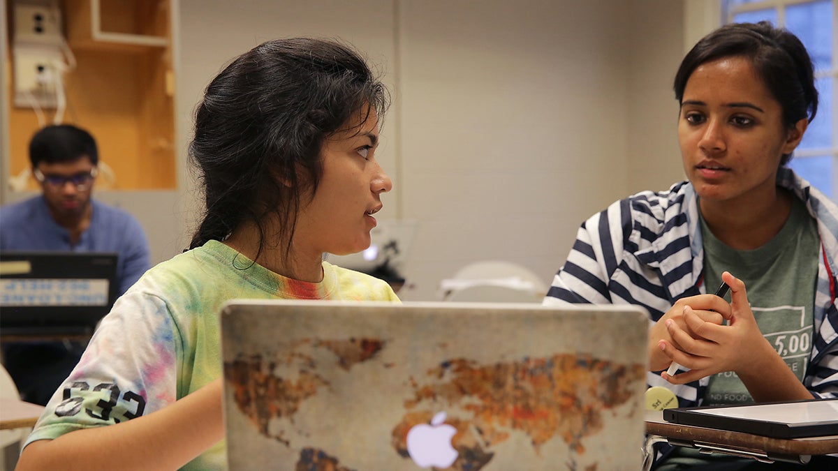 Two students working on a laptop in the Writing and Learning Center.