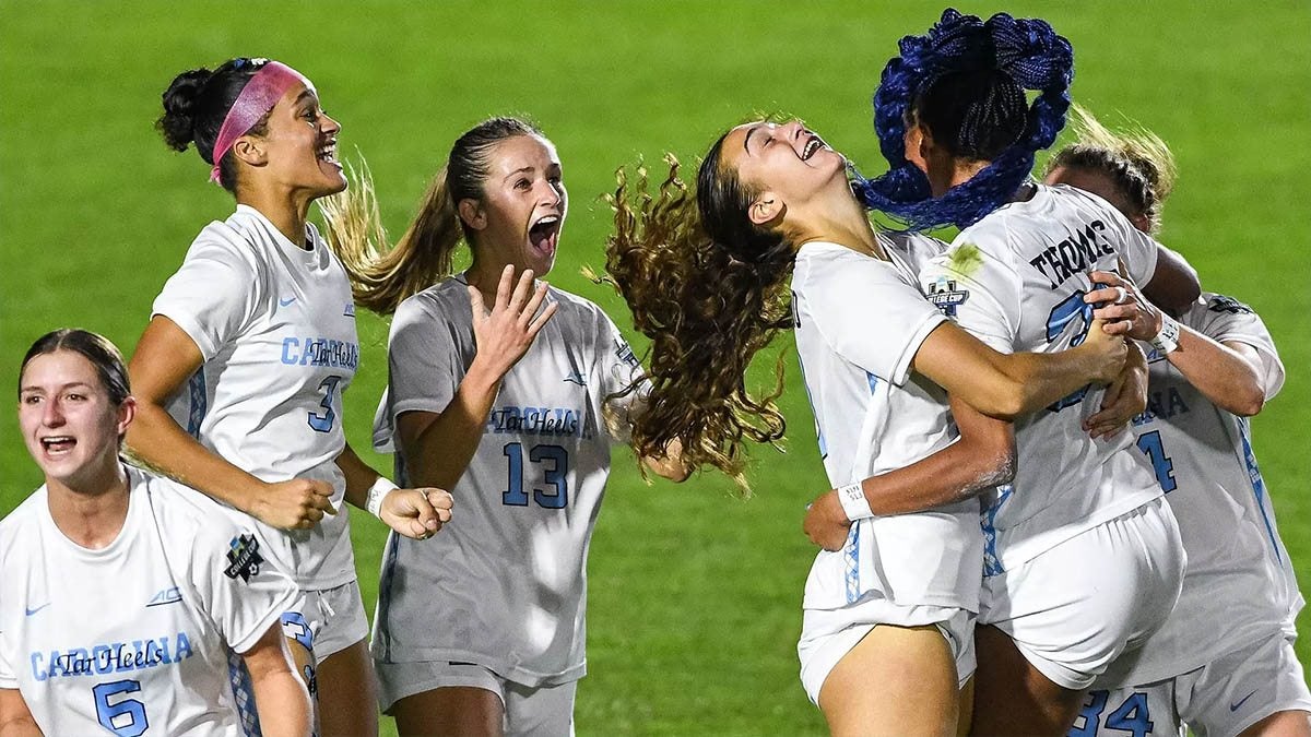 Carolina women's soccer players hug each other on the field after claiming the program's 23rd national title.