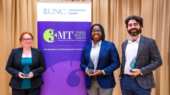 Four student standing in front of a backdrop for the 