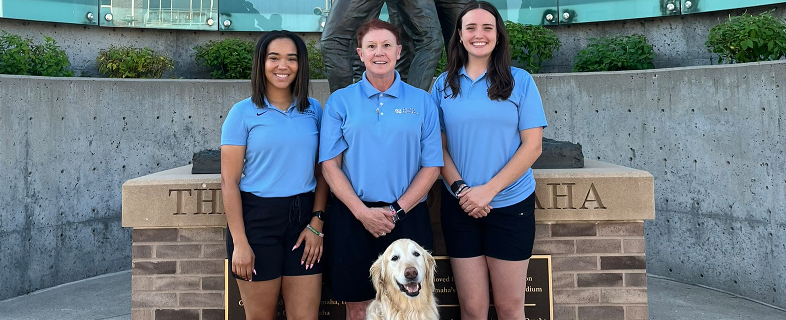 Three individuals posing with Remington.