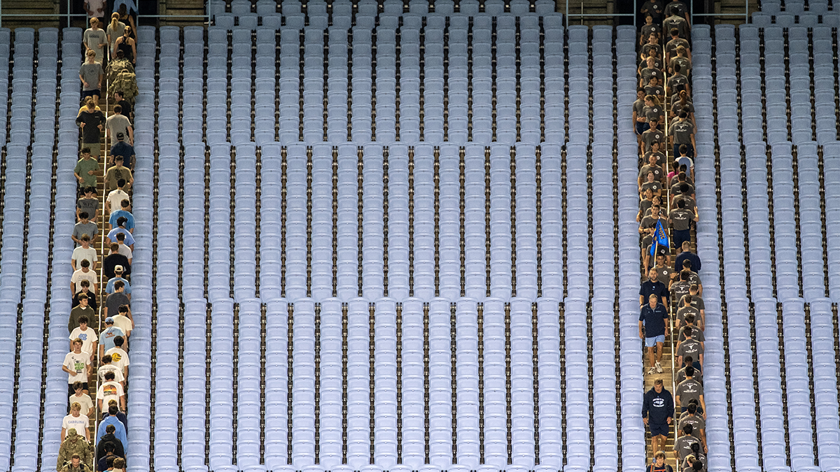 Two rows of participants walking up and down the stairs of Kenan stadium.