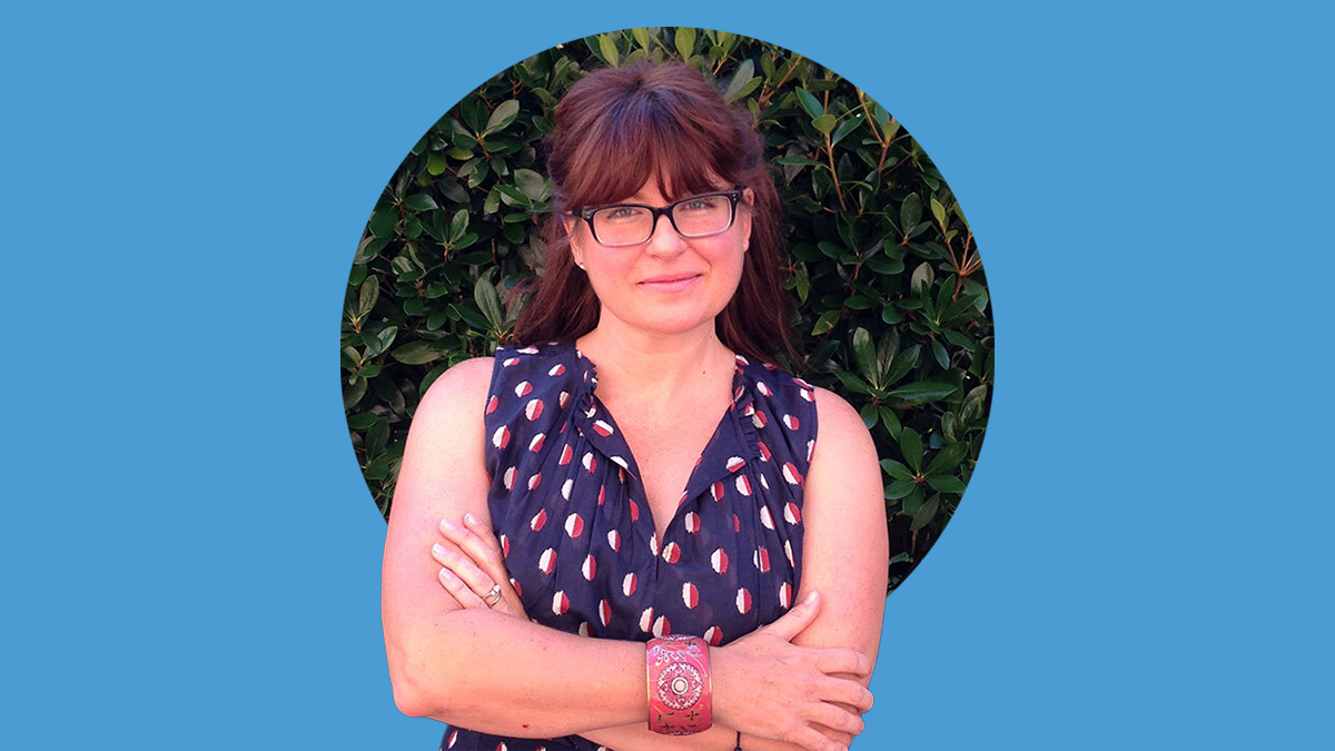 Portrait of Heather Wasser with her arms crossed. The photo is atop a Carolina Blue background.