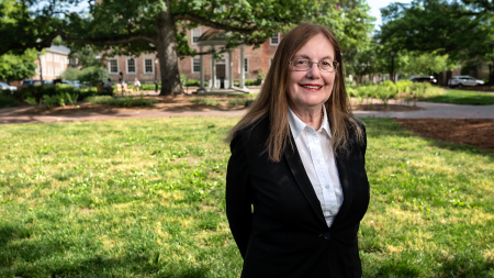 Susan Gaylord in front of the Old Well.