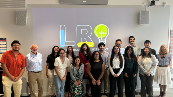 A picture of a small group standing in front a screen with headshots was from La Conferencia, the CLCs conference each year, this was where scholars were able to share their experiences and findings.