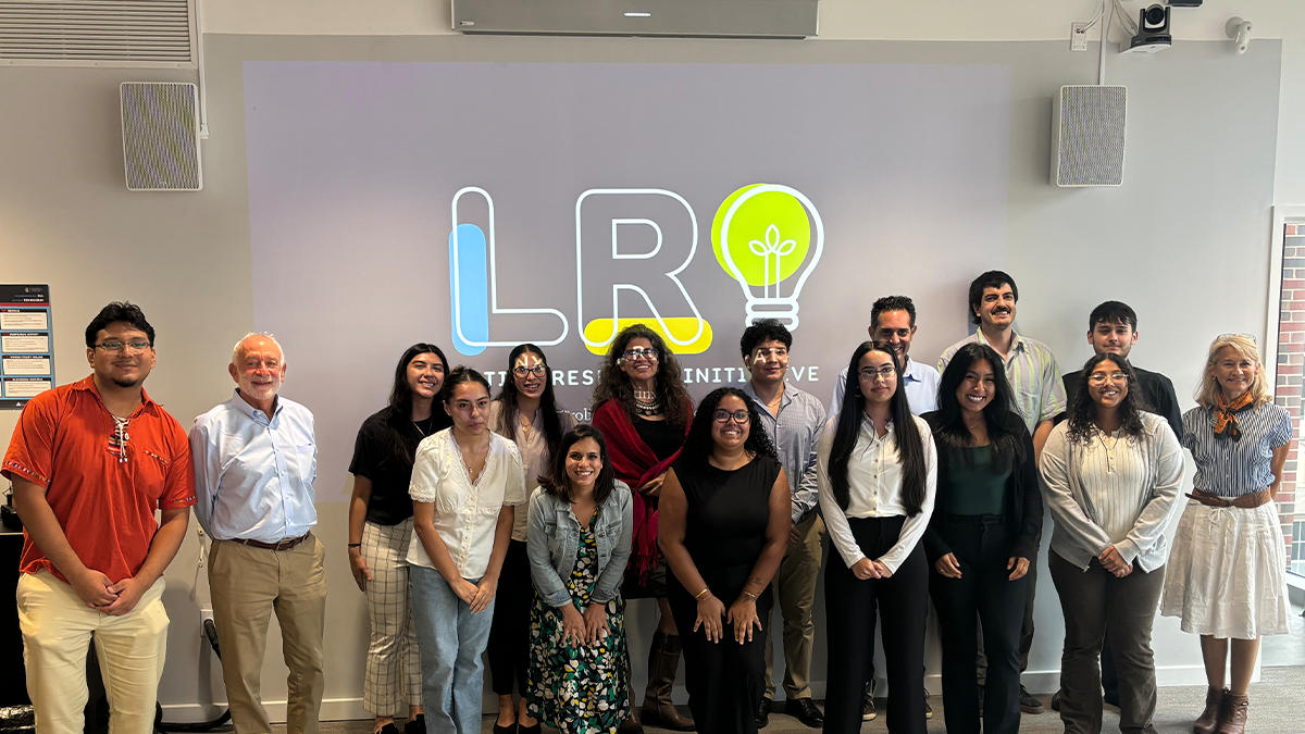A picture of a small group standing in front a screen with headshots was from La Conferencia, the CLCs conference each year, this was where scholars were able to share their experiences and findings.