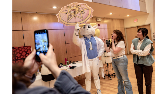 U.N.C. mascot Rameses visits the Graduate Costume Production Program table.