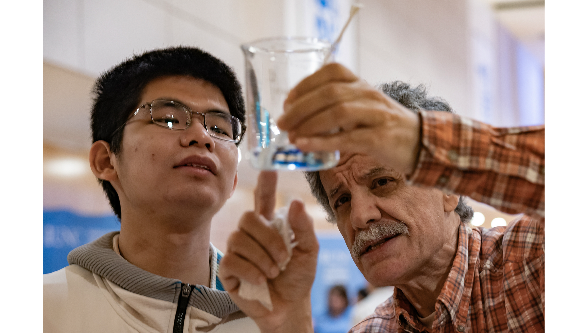 Roberto Camassa (right), a Kenan Distinguished Professor in the Mathematics department, talks to juinor Yuanzhuo Sun at the Joint Fluids Lab table.