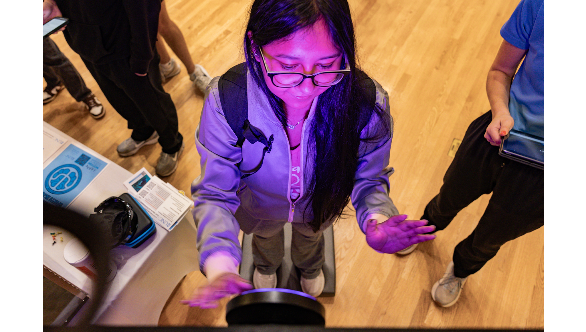 First-year student Vivial Villa Tapia participates in an experiment that tests upper extremity reaction time at the Exercise and Sport Science table.