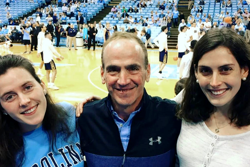 Sean Kelly with his two daughters Brigid and Clara at a Carolina basketball game.