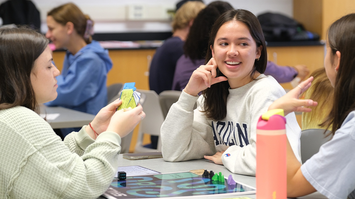 Students conversing at a table.